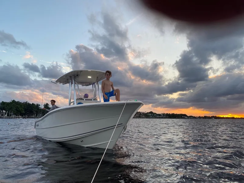 Slide: The Image of 2020 Bulls Bay 230 CC boat on water at sunset with people onboard. - 1