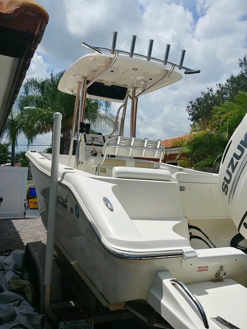 Slide: The Image of 2020 Bulls Bay 230 CC boat with Suzuki engine, parked outdoors. - 11