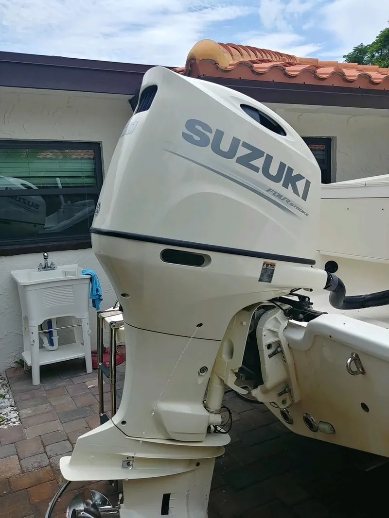 Slide: The Image of Suzuki outboard motor on a 2020 Bulls Bay 230 CC boat, parked outdoors. - 12