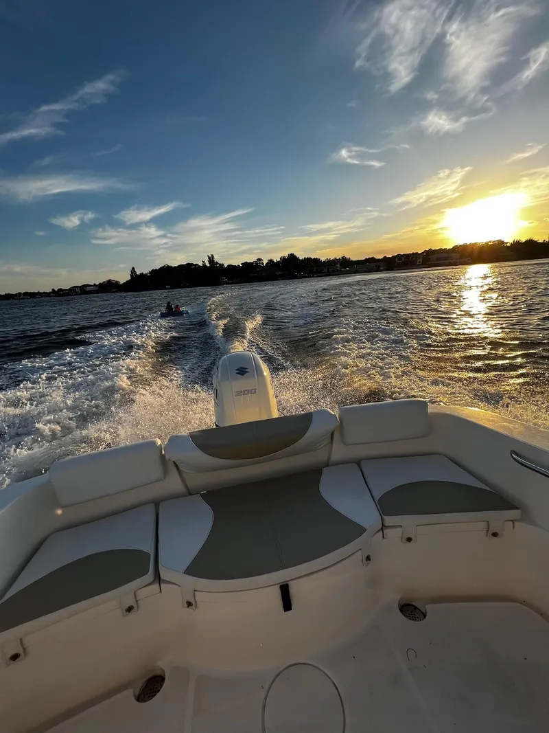 Slide: The Image of Bulls Bay 230 CC boat cruising at sunset, 2020 model, scenic water view. - 15