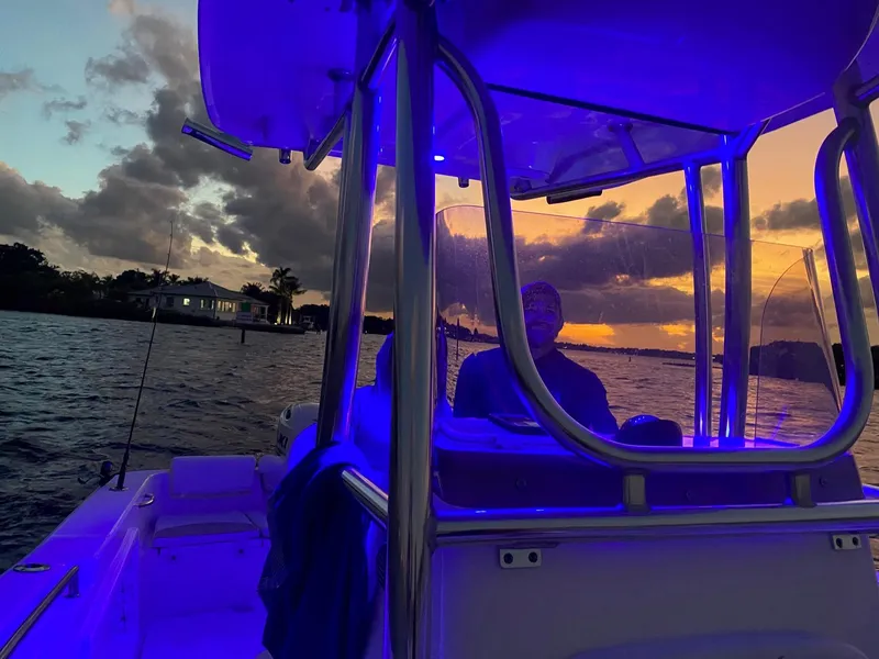 Slide: The Image of Bulls Bay 230 CC boat at sunset with blue interior lighting, 2020 model. - 4