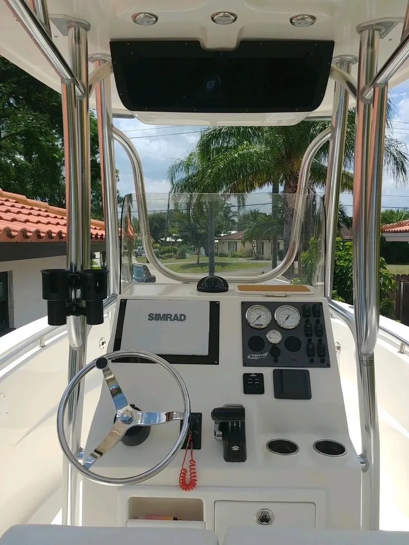 Slide: The Image of 2020 Bulls Bay 230 CC boat dashboard with steering wheel and navigation controls. - 5
