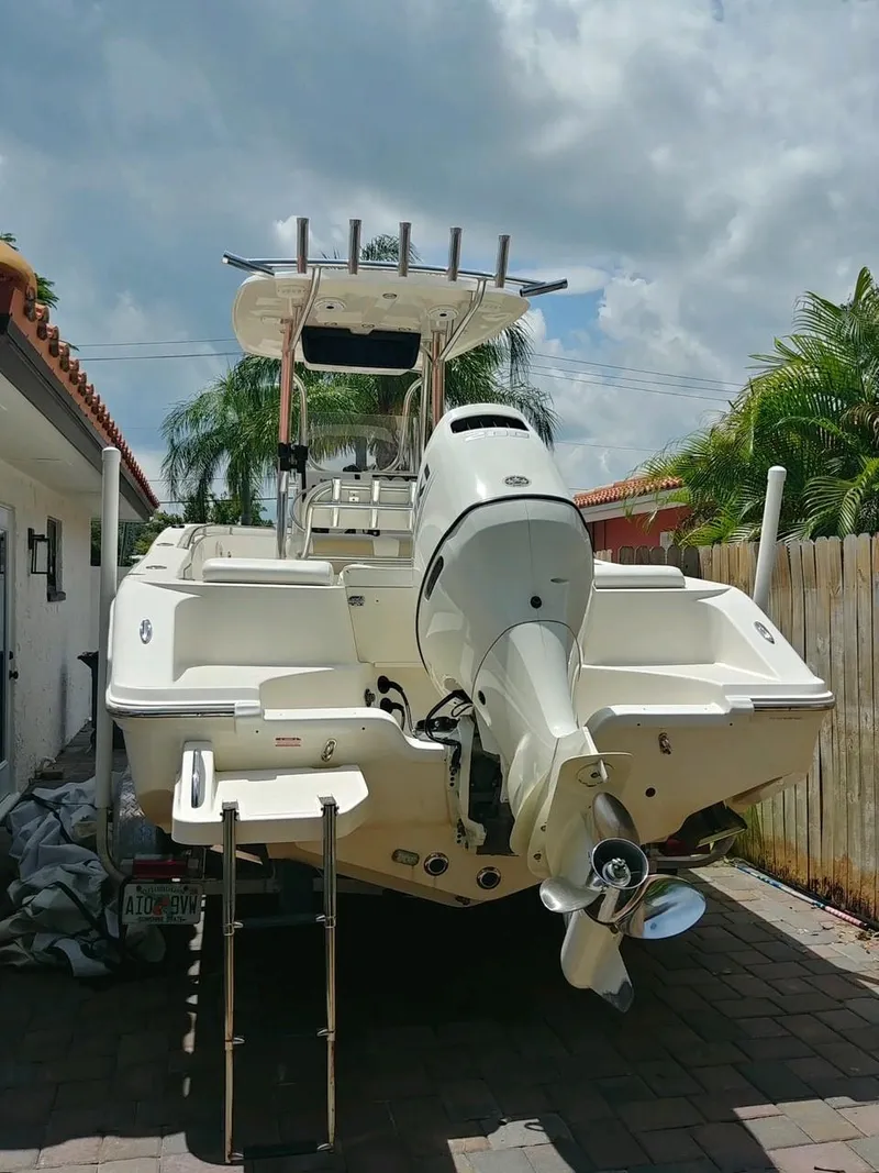 Slide: The Image of 2020 Bulls Bay 230 CC boat with outboard motor, parked outdoors on a sunny day. - 8