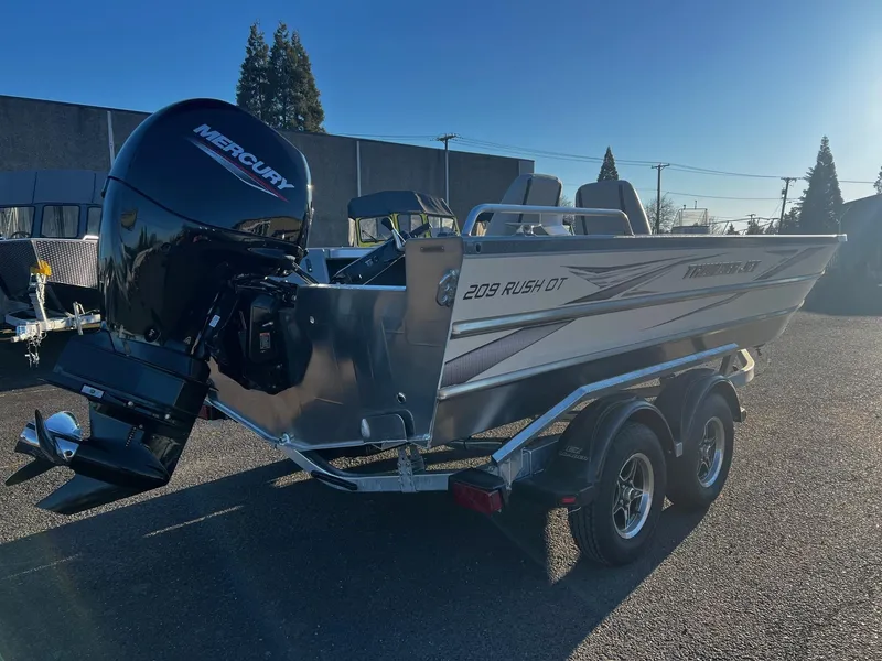 The Image of 2025 Thunder Jet 209 Rush OT boat with Mercury outboard motor on a trailer. - 1