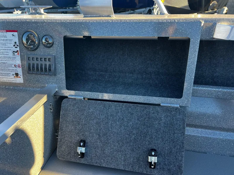 Slide: The Image of 2025 Thunder Jet 209 Rush OT boat dashboard with open storage compartment. - 11