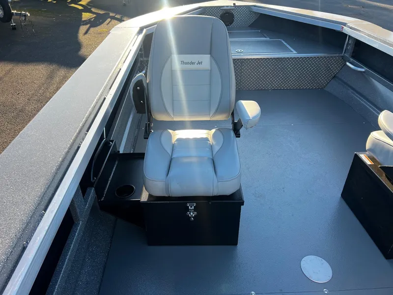 Slide: The Image of 2025 Thunder Jet 209 Rush OT boat interior with gray seating and storage compartments. - 21