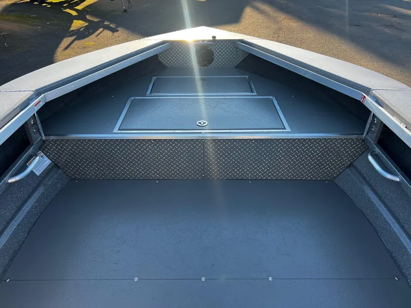 Slide: The Image of 2025 Thunder Jet 209 Rush OT boat interior with storage compartments and diamond plate accents. - 23