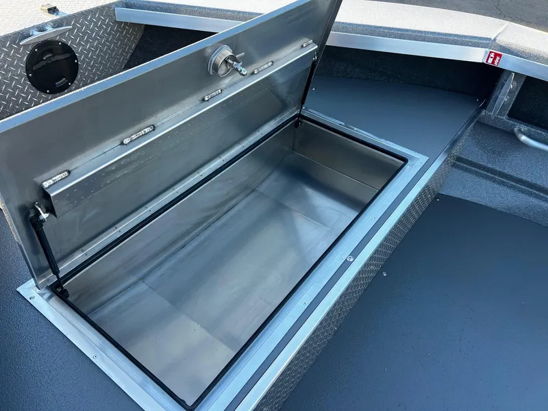 Slide: The Image of Open storage compartment in 2025 Thunder Jet 209 Rush OT boat. - 25