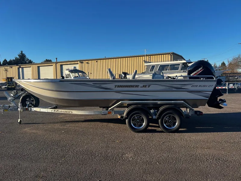 Slide: The Image of 2025 Thunder Jet 209 Rush OT boat on trailer, parked outdoors. - 6