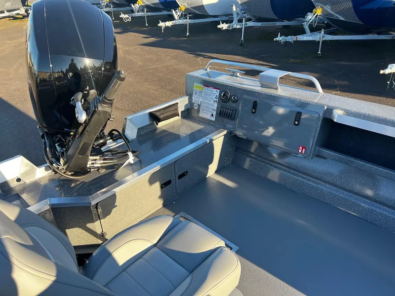 Slide: The Image of 2025 Thunder Jet 209 Rush OT boat interior with motor and seating. - 9