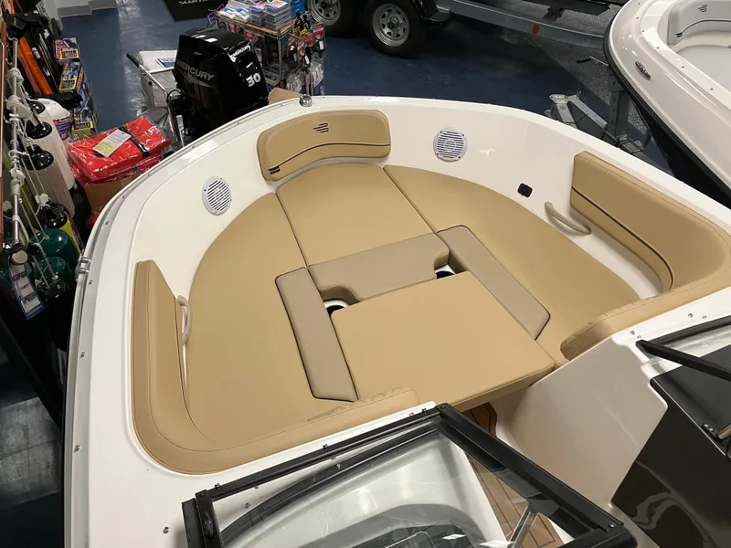 Slide: The Image of 2024 Bayliner VR5 Bowrider OB with tan seating in showroom display. - 13