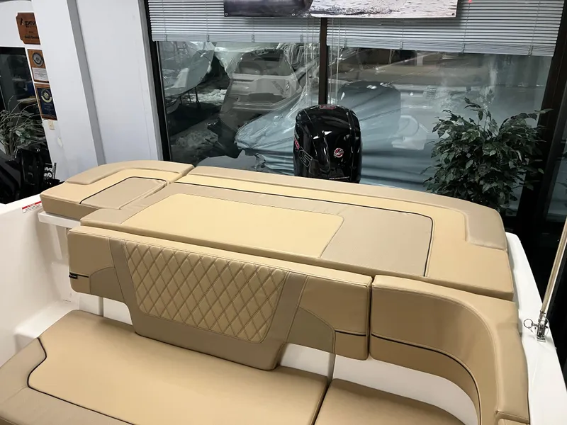 Slide: The Image of 2024 Bayliner VR5 Bowrider OB interior with tan seating and modern design. - 6
