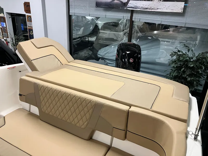 Slide: The Image of 2024 Bayliner VR5 Bowrider OB interior with tan seating and modern design. - 7