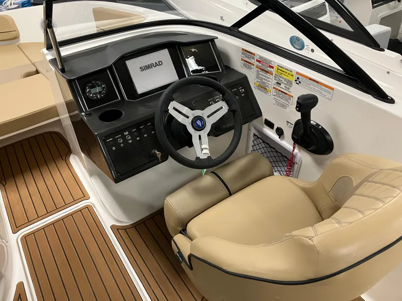 Slide: The Image of 2024 Bayliner VR5 Bowrider OB cockpit with steering wheel and control panel. - 9