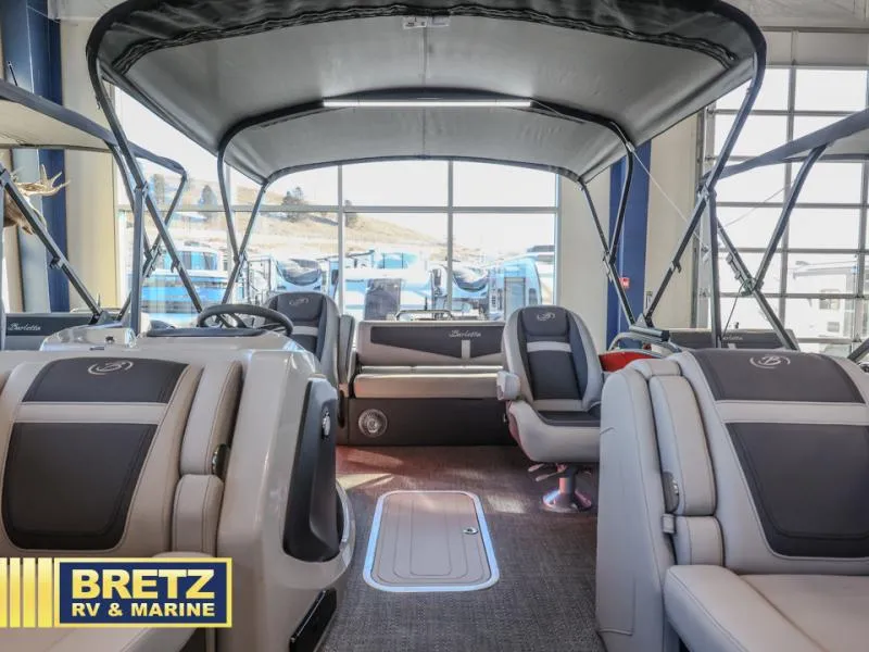 Slide: The Image of 2025 Cabrio Ultra-Lounge 22UC interior with luxurious seating at Bretz RV & Marine showroom. - 13