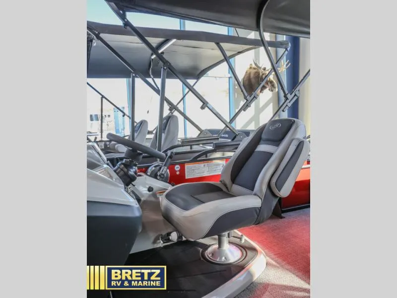 Slide: The Image of 2025 Cabrio Ultra-Lounge 22UC boat interior with steering wheel and comfortable seating. - 14