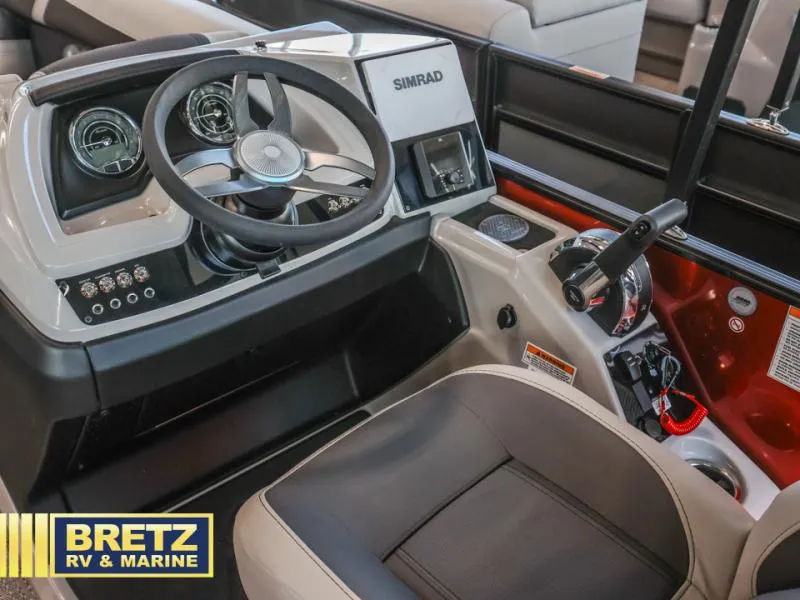 Slide: The Image of 2025 Cabrio Ultra-Lounge 22UC boat dashboard with steering wheel and controls. - 15
