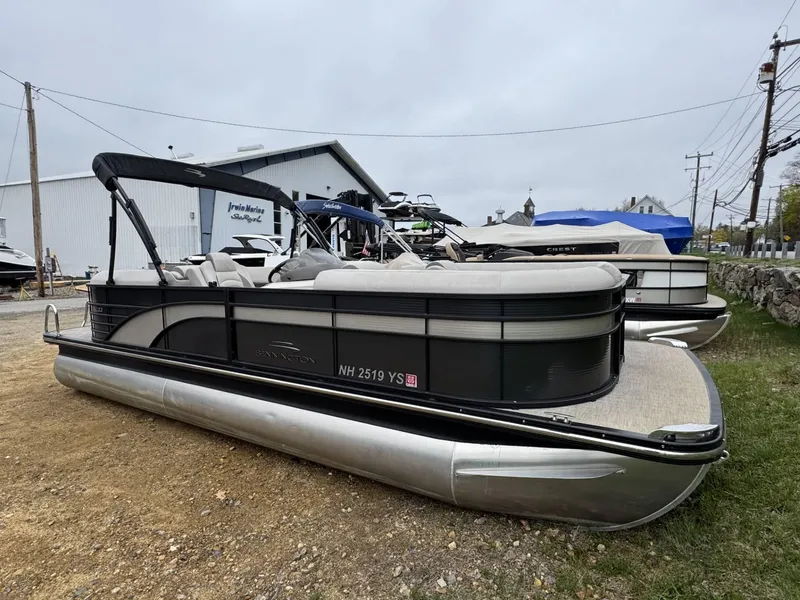 Slide: The Image of 2017 Bennington 226 GSR pontoon boat parked on gravel near marina. - 1