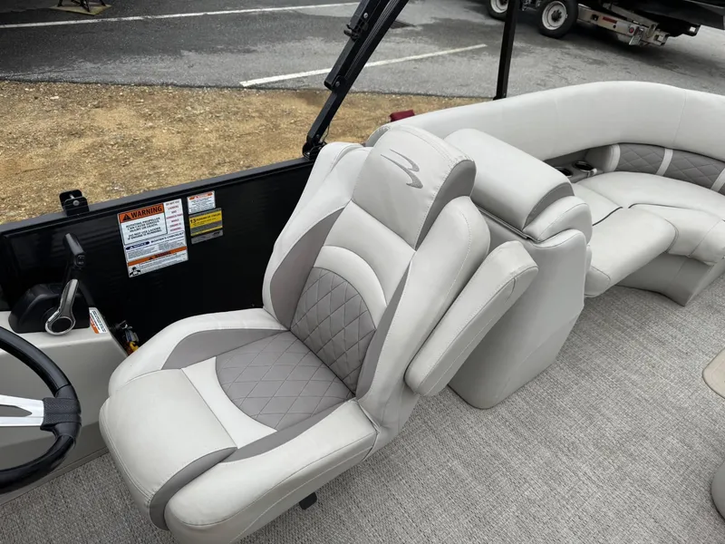 Slide: The Image of Luxurious seating on a 2017 Bennington 226 GSR pontoon boat, featuring plush upholstery and ergonomic design. - 5