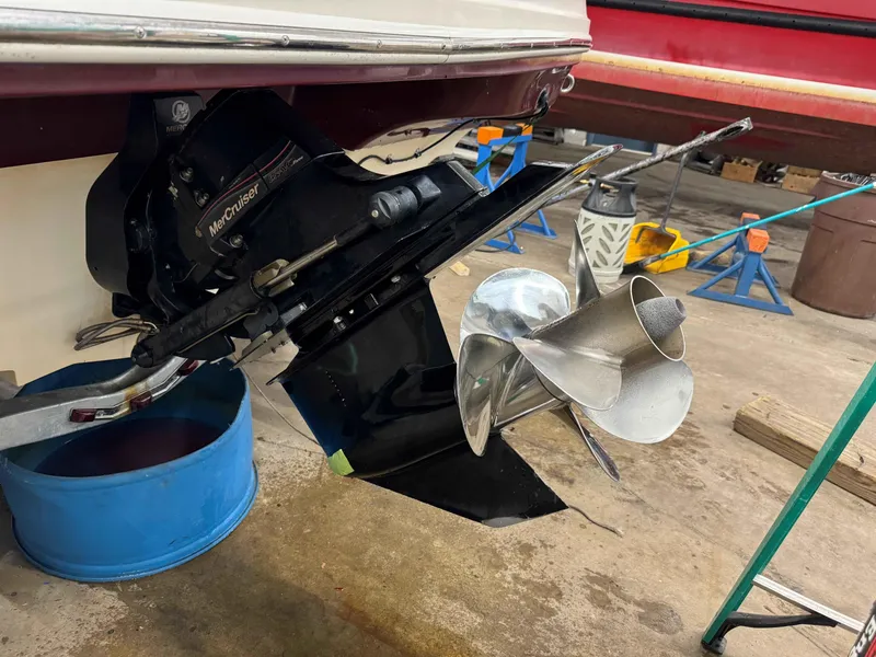 Slide: The Image of 2007 Sea Ray 230 Select boat with MerCruiser outdrive and propeller in a workshop setting. - 5