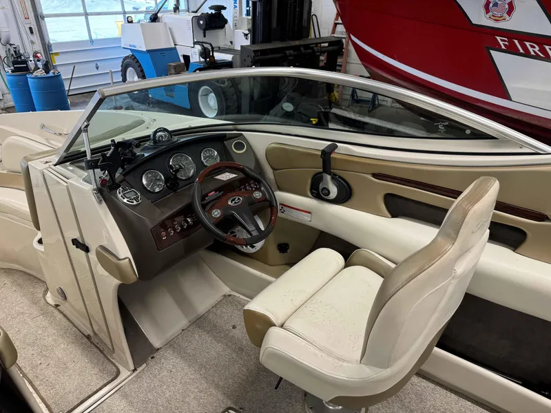 Slide: The Image of 2007 Sea Ray 230 Select boat interior with steering wheel and dashboard controls. - 7
