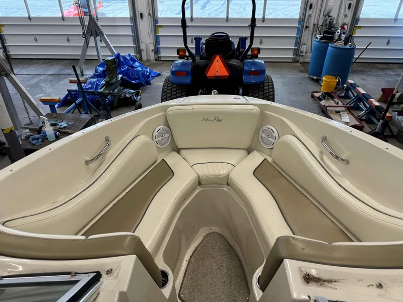 Slide: The Image of Interior of a 2007 Sea Ray 230 Select boat in a garage setting. - 8