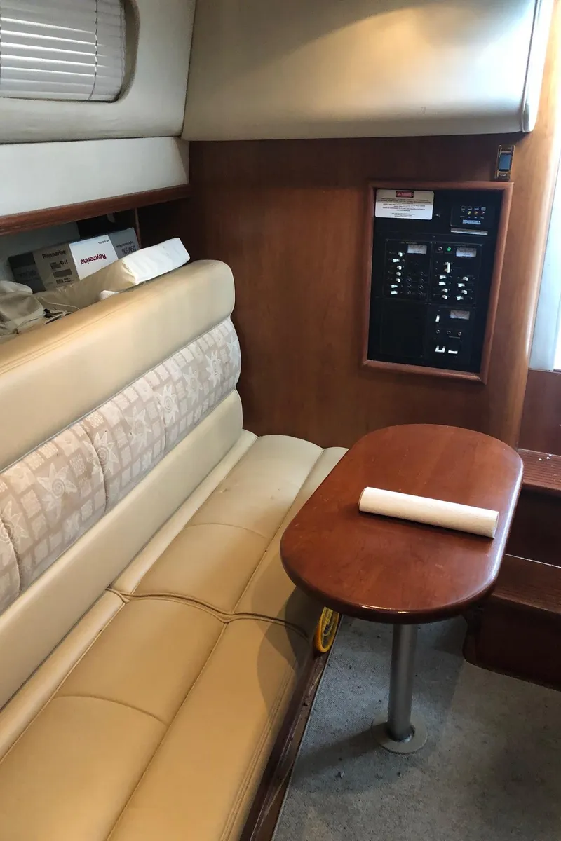 Slide: The Image of 2000 Rampage 30 Express cabin interior with beige seating and wooden table. - 10