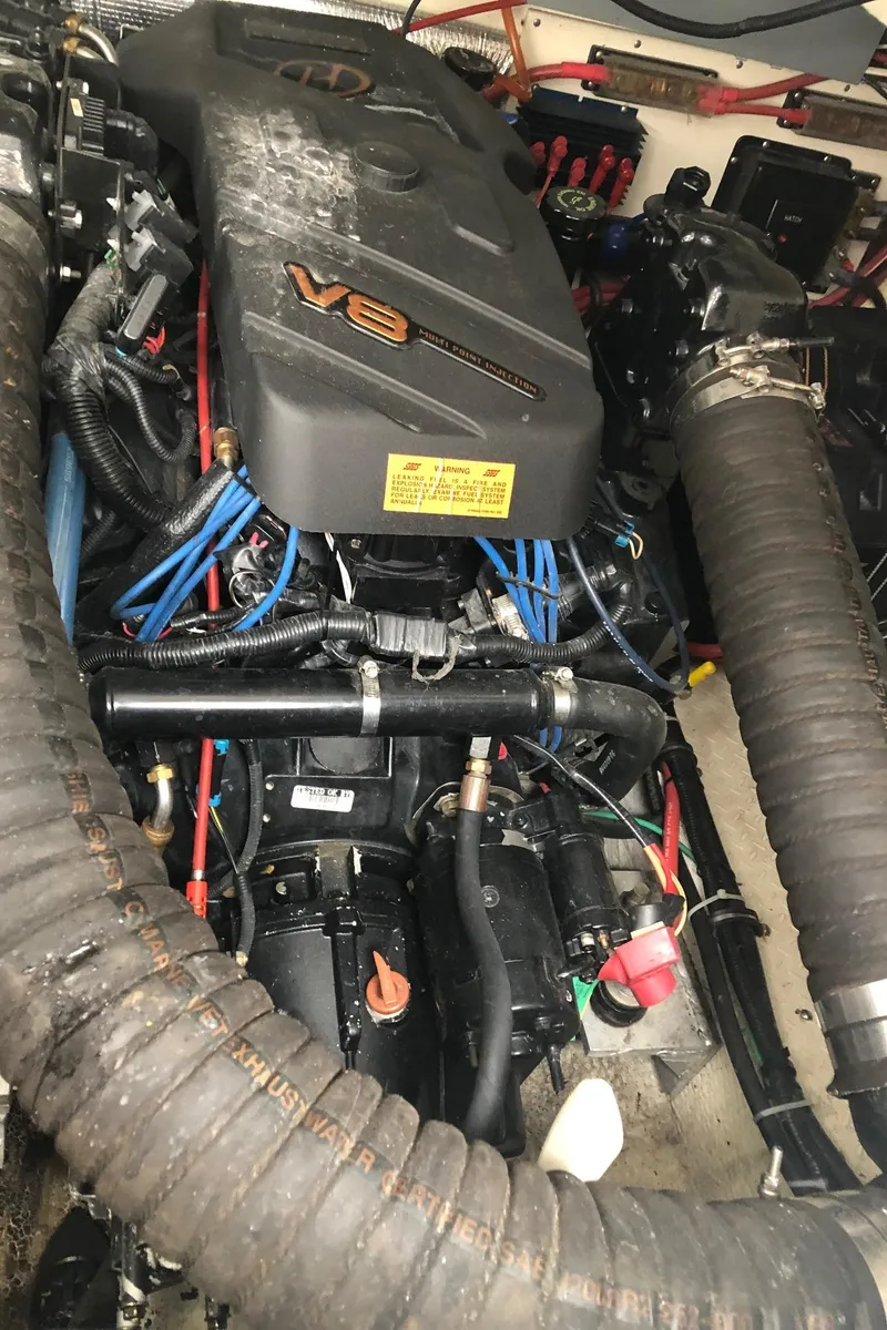 Slide: The Image of V8 engine of a 2000 Rampage 30 Express boat, showcasing intricate wiring and components. - 12