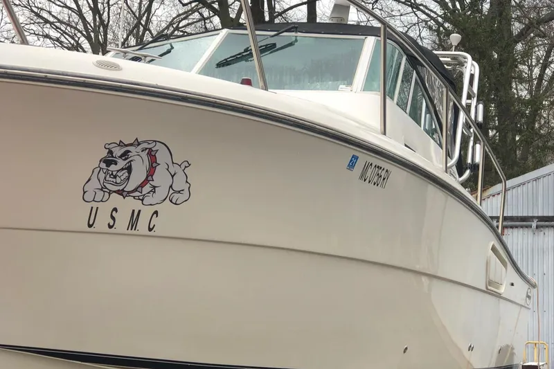 Slide: The Image of 2000 Rampage 30 Express boat with USMC bulldog logo on the hull. - 2