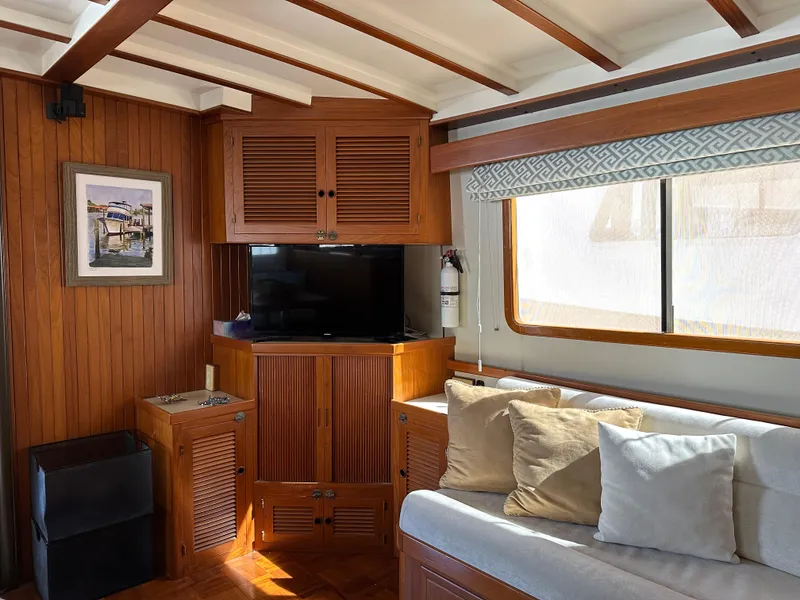 Slide: The Image of Interior of 1997 Kadey-Krogen 48 Whaleback yacht with wood paneling and cozy seating area. - 11