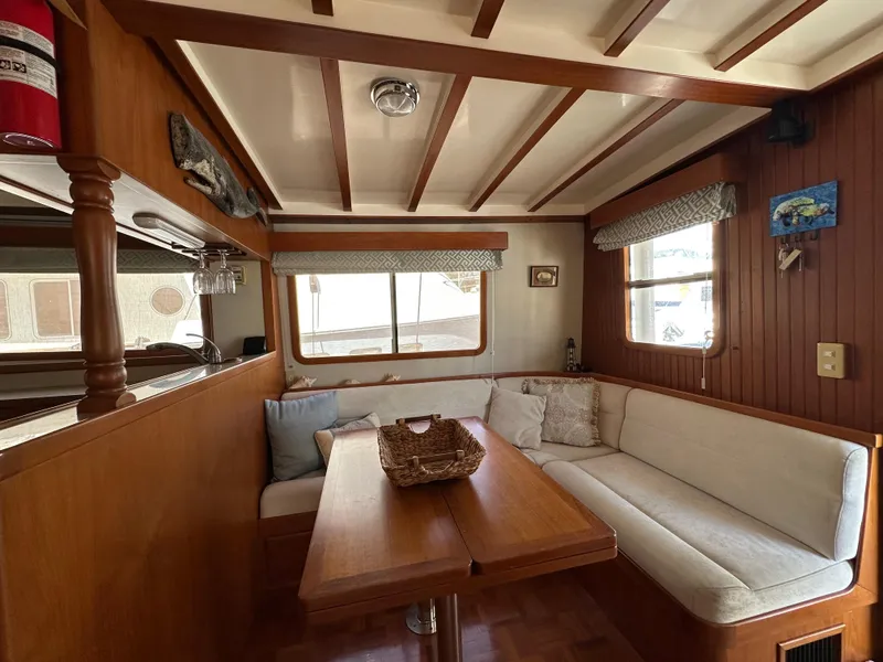 Slide: The Image of Cozy interior of 1997 Kadey-Krogen 48 Whaleback yacht with wood accents and seating area. - 12