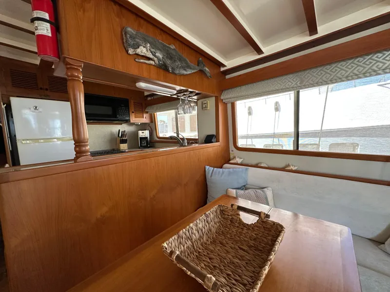 Slide: The Image of Interior of 1997 Kadey-Krogen 48 Whaleback yacht with wooden finishes and cozy seating area. - 14