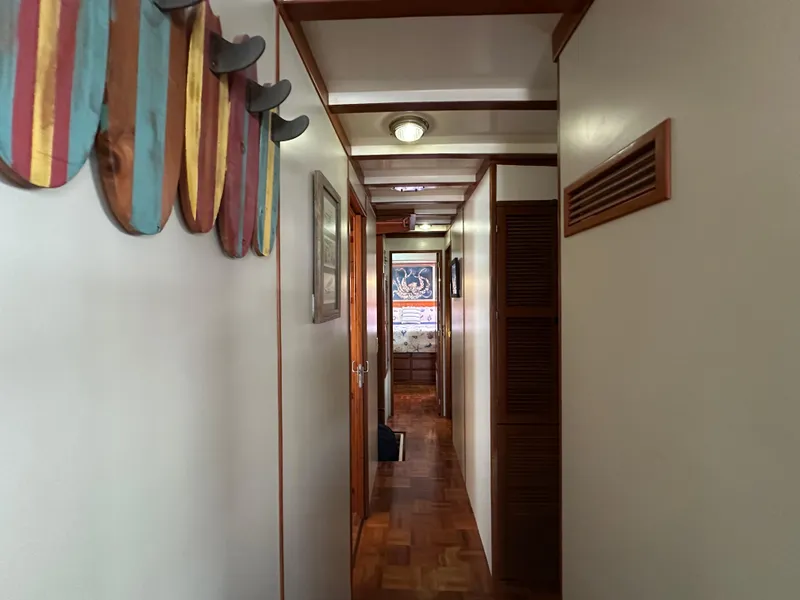 Slide: The Image of Hallway inside 1997 Kadey-Krogen 48 Whaleback yacht with wooden accents and colorful wall decor. - 17