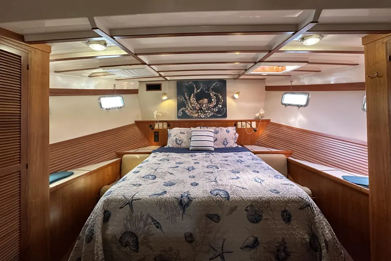 Slide: The Image of Narrow hallway in a 1997 Kadey-Krogen 48 Whaleback yacht, leading to a cozy bedroom. - 18