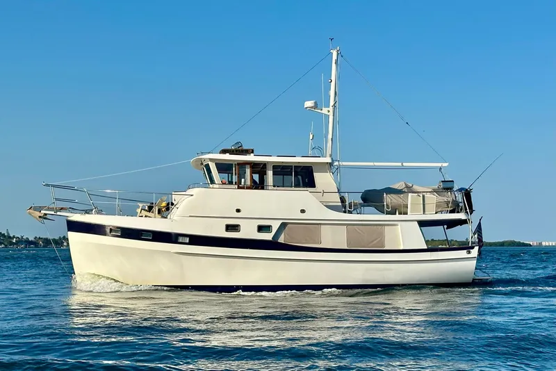 Slide: The Image of 1997 Kadey-Krogen 48 Whaleback yacht cruising on calm blue waters. - 2