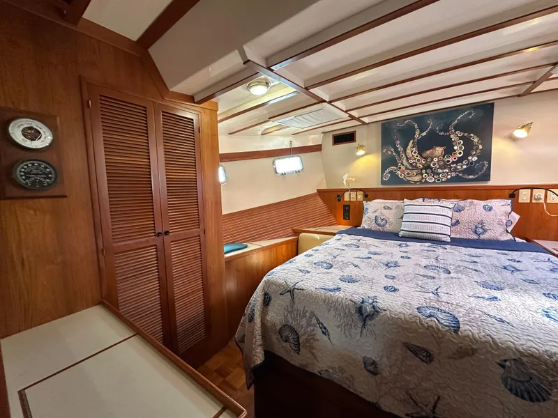Slide: The Image of Cozy bedroom in 1997 Kadey-Krogen 48 Whaleback yacht with nautical decor and wood paneling. - 20