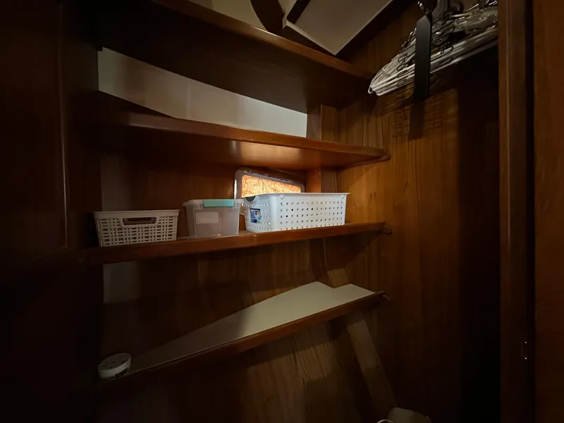 Slide: The Image of 1997 Kadey-Krogen 48 Whaleback cabin with wooden interior and nautical-themed bedding. - 22