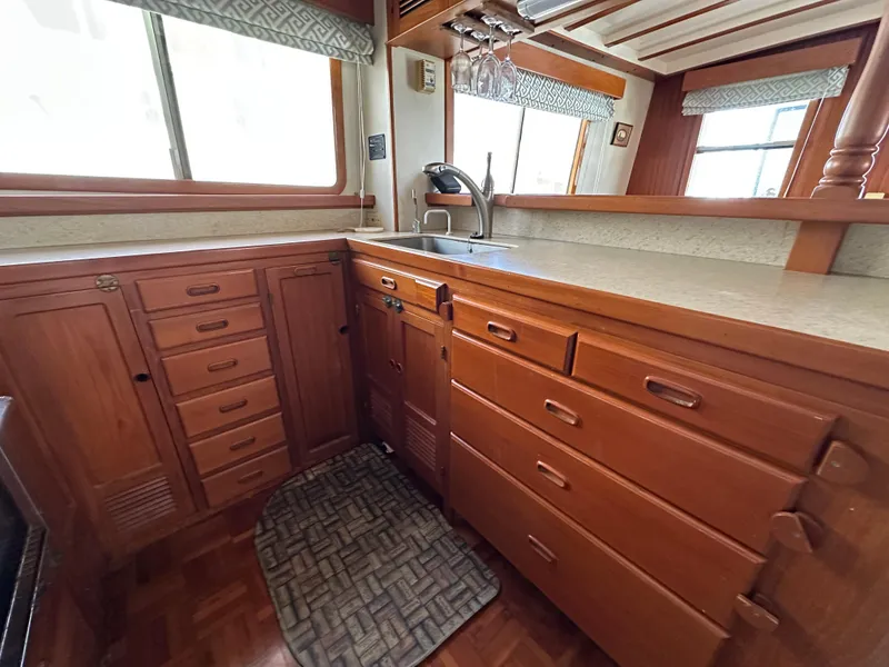 Slide: The Image of Cozy seating area in 1997 Kadey-Krogen 48 Whaleback yacht with wooden interior and cushions. - 29