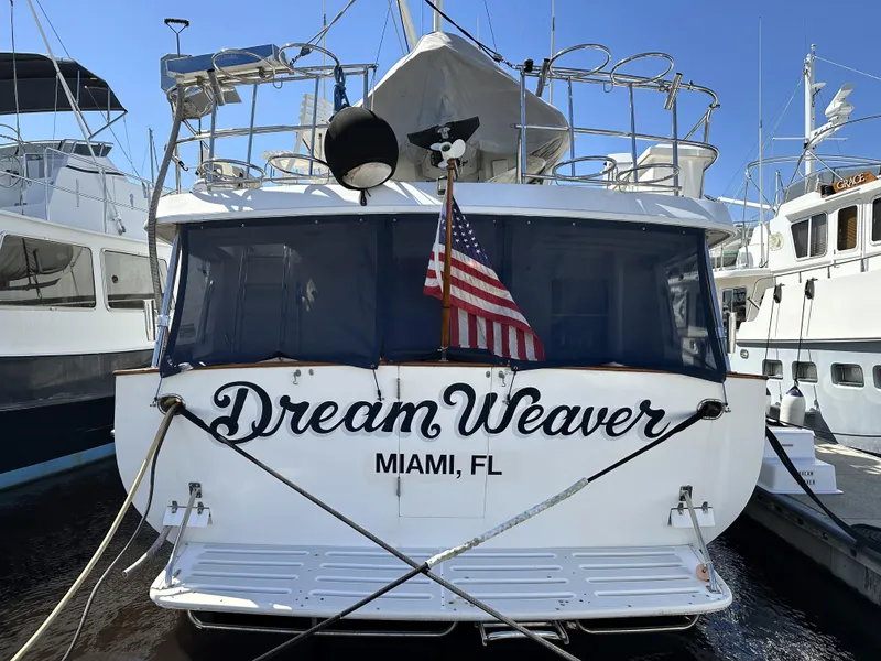 Slide: The Image of Kadey-Krogen 48 Whaleback yacht "Dream Weaver" docked in Miami, FL, with American flag. - 4