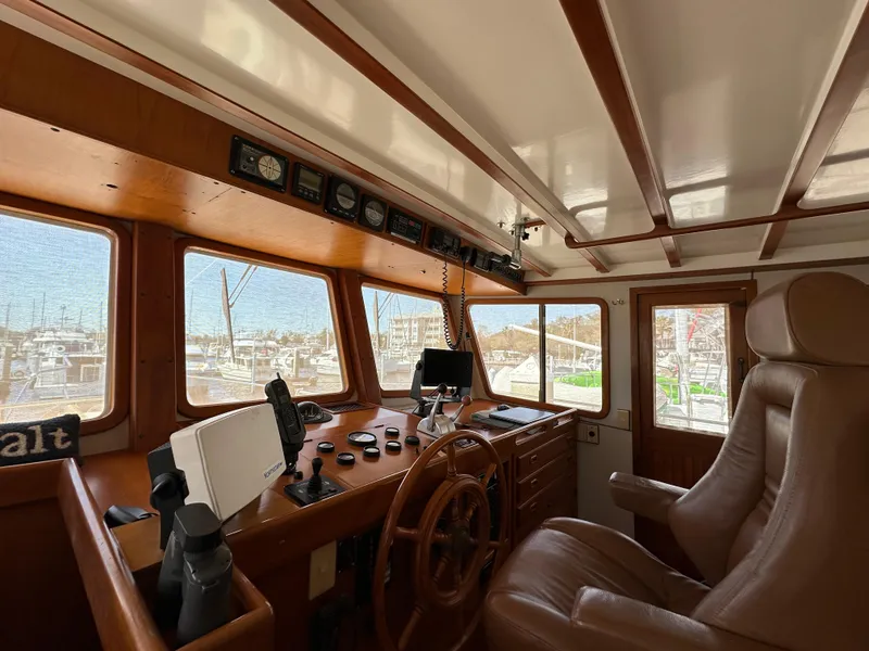 Slide: The Image of Interior of 1997 Kadey-Krogen 48 Whaleback yacht with wood paneling and captain's chair. - 40