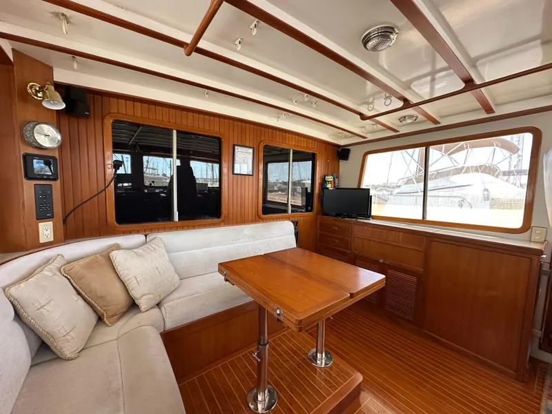 Slide: The Image of 1997 Kadey-Krogen 48 Whaleback interior with captain's chair, wooden table, and navigation equipment. - 41