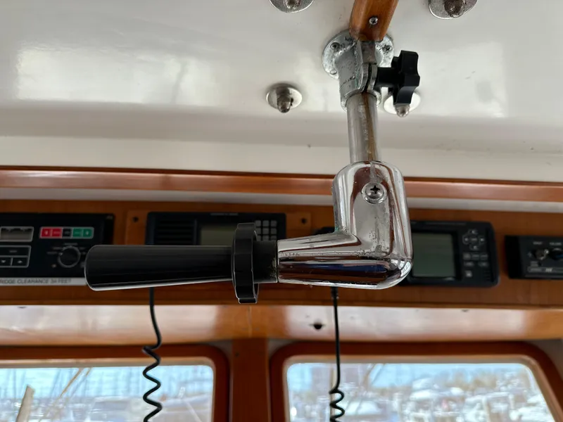 Slide: The Image of 1997 Kadey-Krogen 48 Whaleback interior with open storage compartment and monitor. - 47