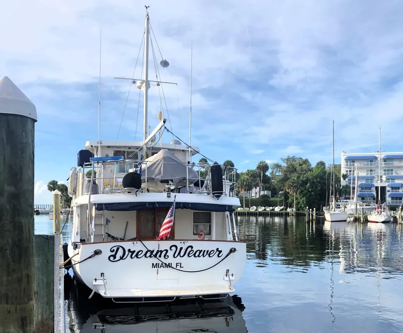 Slide: The Image of Kadey-Krogen 48 Whaleback yacht "Dream Weaver" docked in a serene marina, 1997 model. - 5
