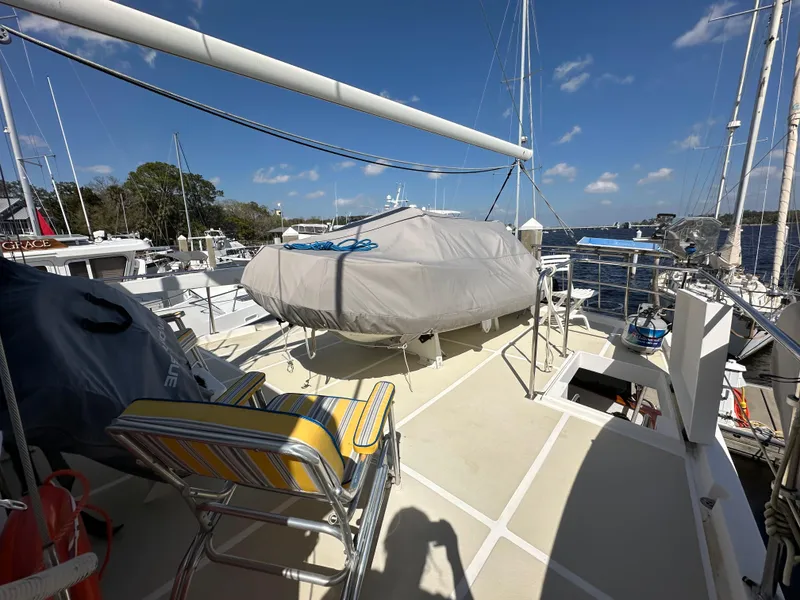 Slide: The Image of 1997 Kadey-Krogen 48 Whaleback yacht deck with storage compartments and railing. - 51