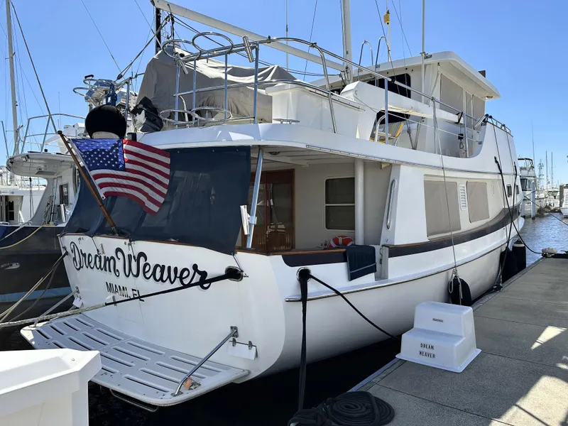 Slide: The Image of 1997 Kadey-Krogen 48 Whaleback yacht docked with American flag displayed. - 7