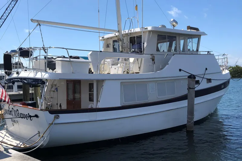 Slide: The Image of 1997 Kadey-Krogen 48 Whaleback yacht docked at marina, side view. - 8