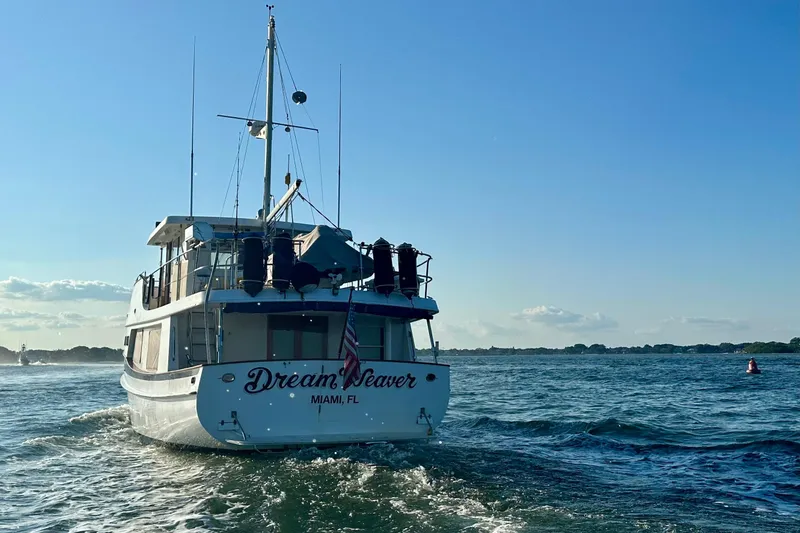 Slide: The Image of Kadey-Krogen 48 Whaleback yacht, 1997 model, cruising on open water under clear skies. - 82