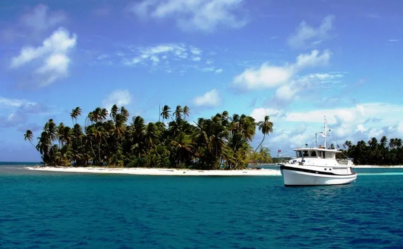 Slide: The Image of Kadey-Krogen 48 Whaleback yacht near tropical island with palm trees, 1997 model. - 83