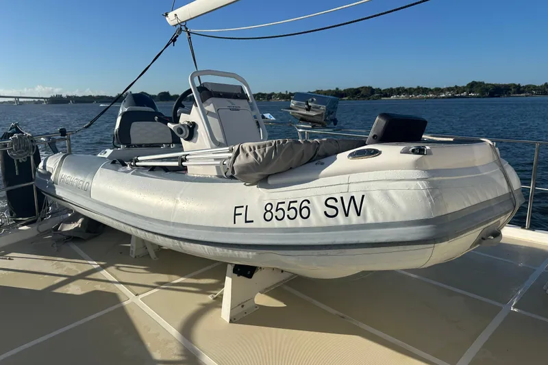 Slide: The Image of Inflatable boat on Kadey-Krogen 48 Whaleback, 1997 model, docked by the water. - 84
