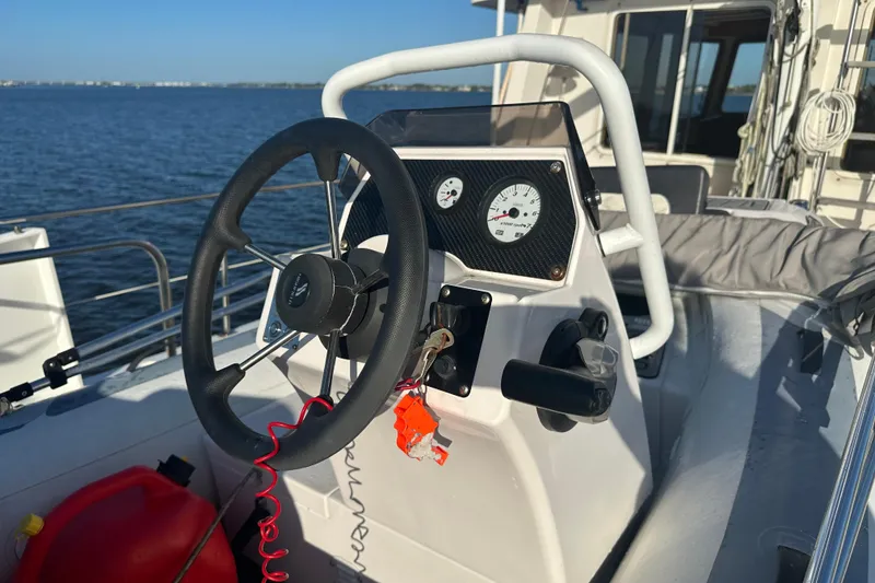 Slide: The Image of Steering console of a 1997 Kadey-Krogen 48 Whaleback boat on open water. - 85